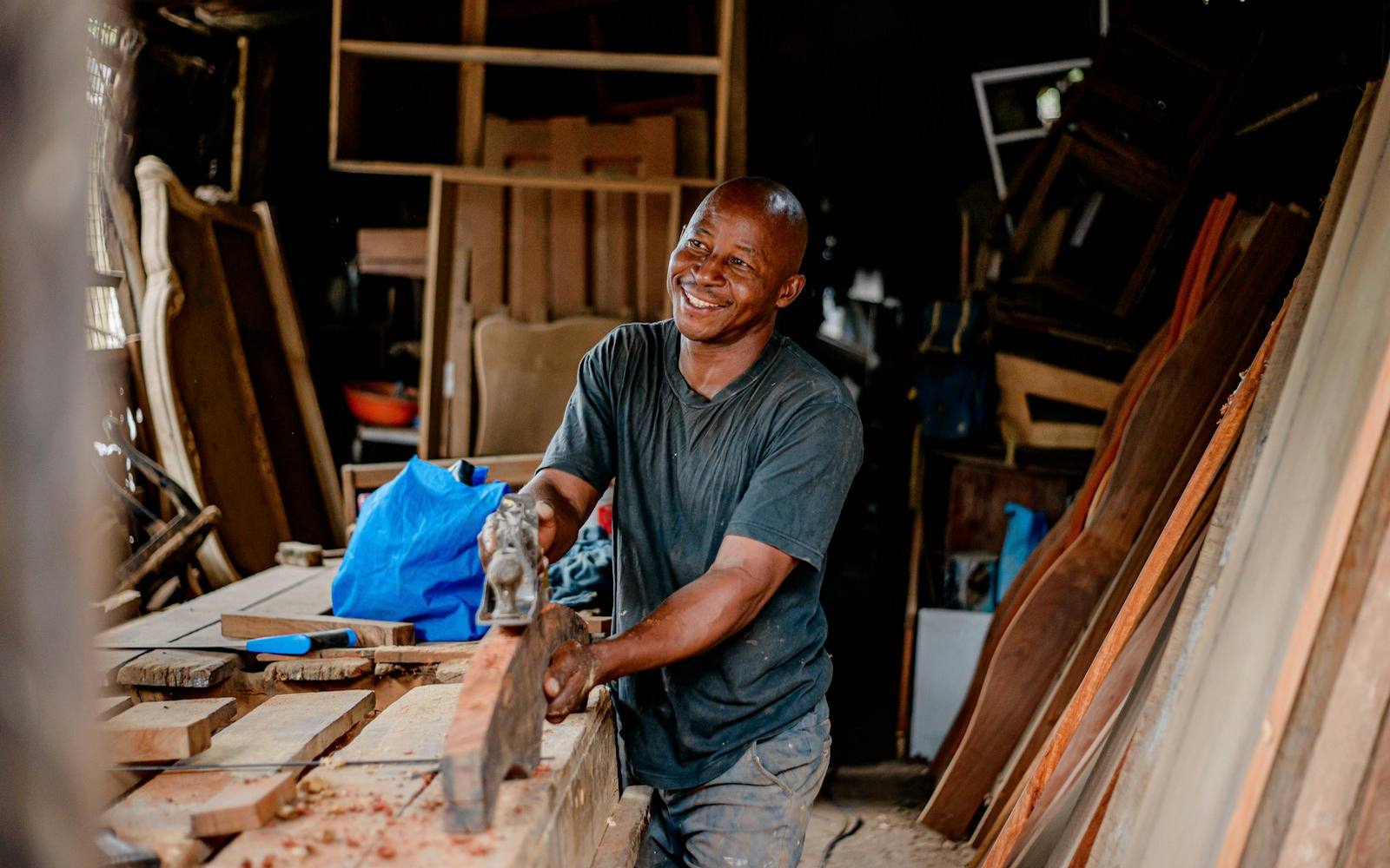 Craftsman planing wood in the workshop